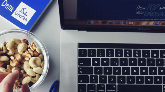 Schale mit Nüssen neben einem Laptop 