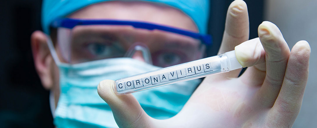 Arzt mit Blutentnahmeröhrchen mit Aufschrift Coronavirus