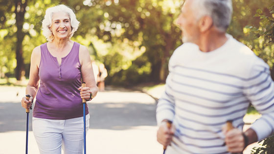 Älteres Paar beim Nordic Walken