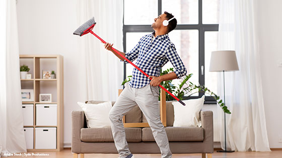 Mann mit Besen hört Musik